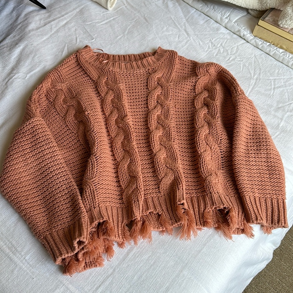 Cable knit distressed hem sweater
